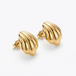 Pair of gold shell-shaped earrings on a white background