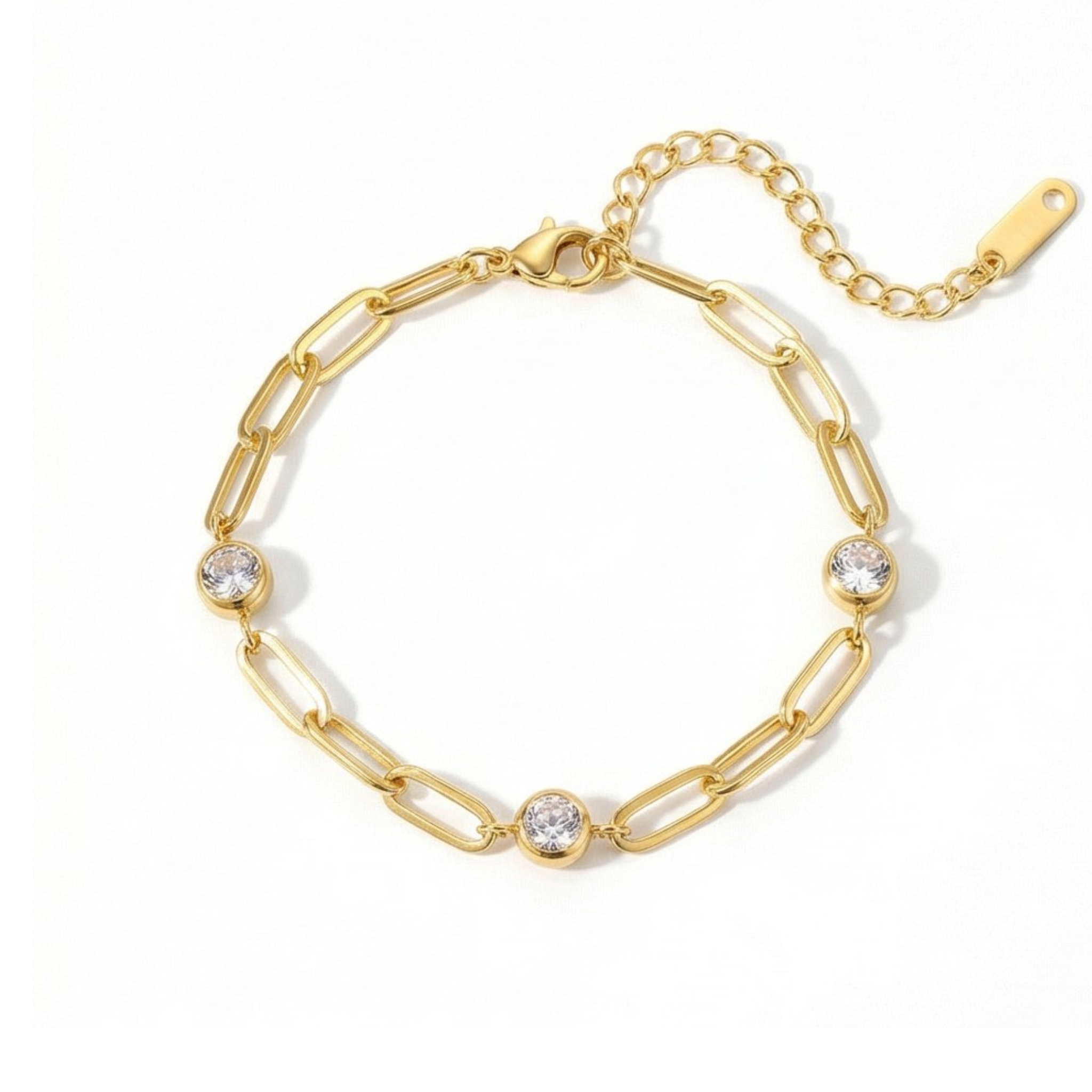 Gold chain bracelet with three diamond-like stones on a white background