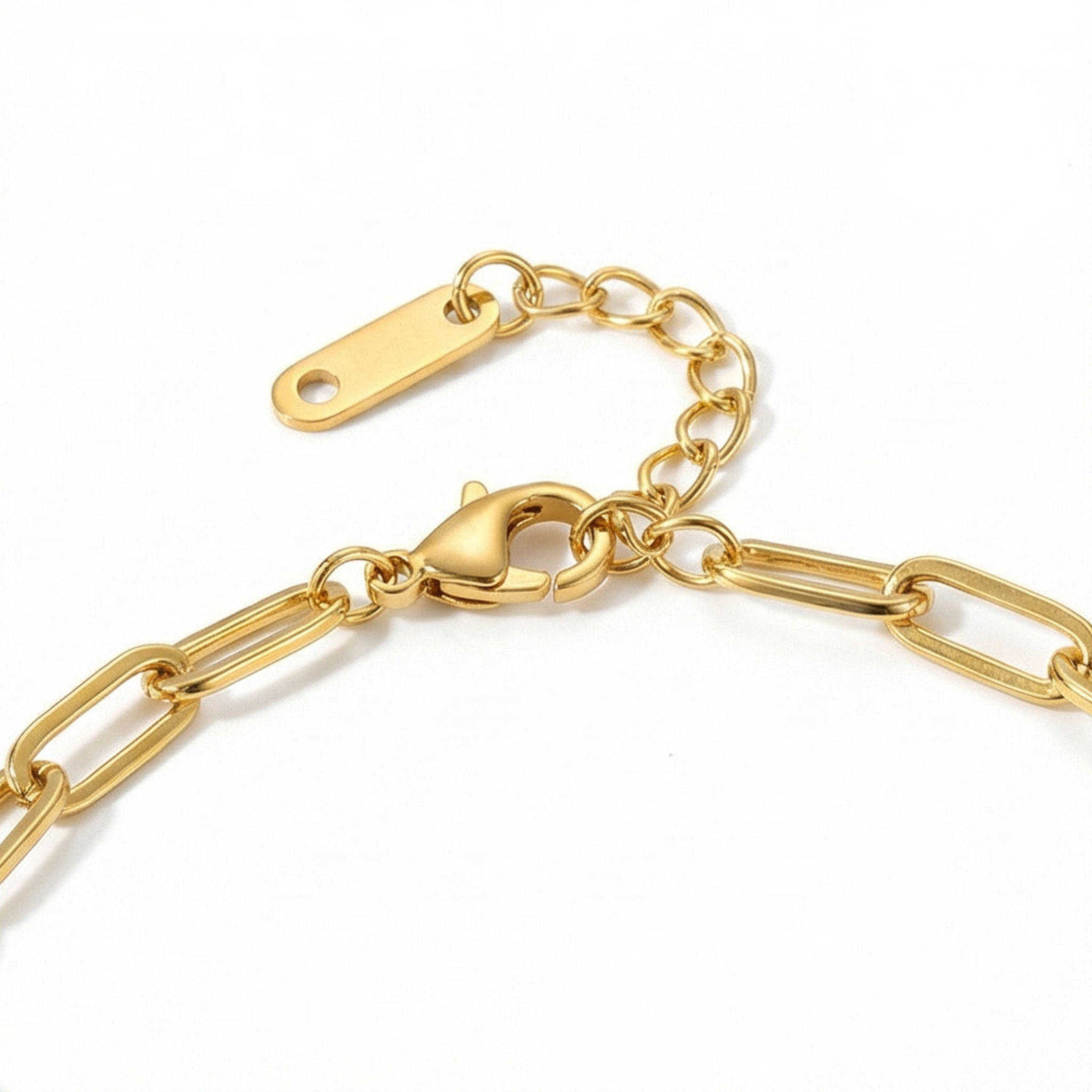 Close up of gold chain bracelet clasp and extender on a white background