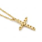 The backside of the Gloryd Signature Cross necklace which is a gold cross pendant necklace with a textured finish and small circular gem details, shown on a clean white background.