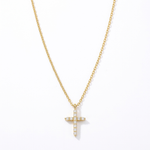 The Glory'd Signature Cross Necklace which is a yellow gold cross pendant necklace adorned with clear round-cut gemstones, suspended from a matching gold chain against a plain white background.