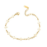 Gold bracelet with links made of mini crosses on a white background