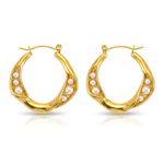 Gold hoop earrings with pearl accents on a white background