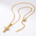 Gold necklace with a cross pendant on a white background