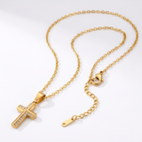 Gold necklace with a cross pendant on a white background