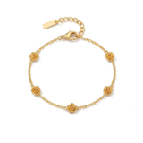 Gold bracelet with five stationary gold rosebud designs spaced out on the chain on a white background