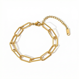 Gold paperclip chain bracelet on a white background